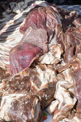 Fresh and raw sheep or lamb meat pieces for sale on the counter top of a butchery shop.
