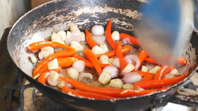Stir-frying chili and garlic in the pan to prepare for cooking, Thai food that consists primarily of spicy