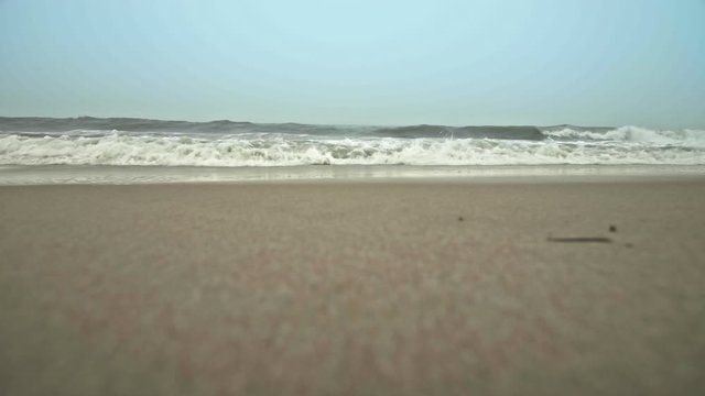 Ocean waves crashing into camera on beach in Dewey Beach, Delaware, Slow Motion