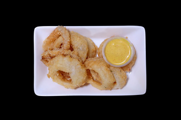 Many pieces of Fried onion on white plate top view with Mayonnaise sauce.