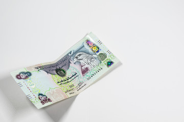 A close up view of United Arab Emirates currency, with white background, UAE Dirhams
