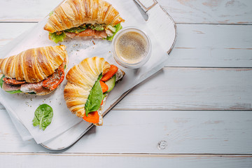 The concept of a hearty and tasty breakfast of fresh classic croissants with a variety of toppings...