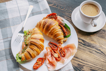 The concept of a hearty and tasty breakfast of fresh classic croissants with a variety of toppings...