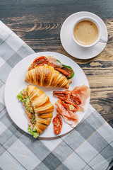 The concept of a hearty and tasty breakfast of fresh classic croissants with a variety of toppings...