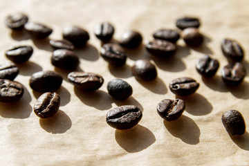 Coffee beans on craft paper in hard sunlight