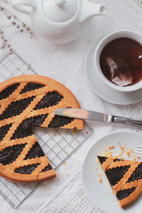 Fruit berry pie and fresh tea on white background