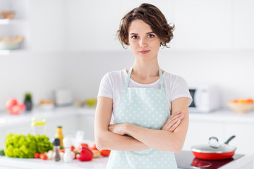 Obraz na płótnie Canvas Photo of beautiful bobbed hairdo housewife holding arms crossed enjoy morning cooking tasty dinner family meeting wear apron t-shirt stand modern kitchen indoors