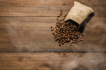 Freshly roasted coffee beans close-up on a dark ninety background backdrop. Coffee beans texture