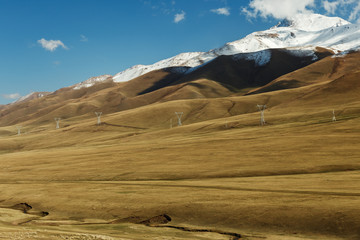electricity pylons in the mountains, Naryn region in Kyrgyzstan.