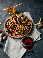 menazhnitsa with nuts dried fruits and honey on a dark background