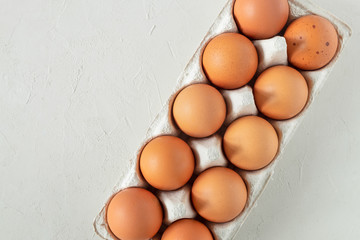 Chicken brown fresh raw eggs in an egg container. Ingredients for cooking. Healthy eating is a concept. Horizontal orientation, view from above, copy space, selective focus.