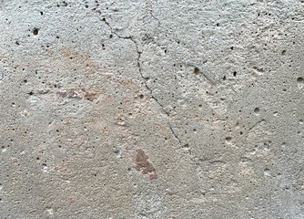 Close up photo of a crack appearing in a concrete foundation. 