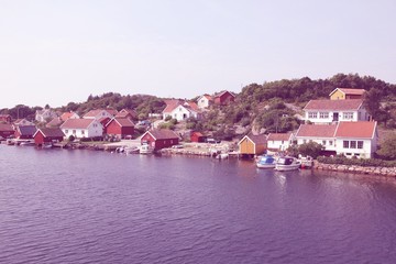Fototapeta na wymiar Norway fishing village near Kristiansand. Vintage processed image style.