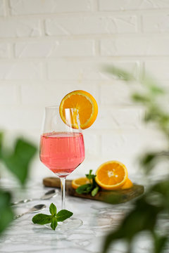 alcoholic drink with champagne and orange, pink color. aperol syringe