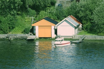 Fototapeta na wymiar Norway boat garage. Retro color filtered style.