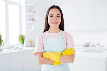 Close-up portrait of her she nice attractive cheerful cheery housewife girl dish washer dishwasher wearing yellow gloves folded arms in modern white light interior style kitchen