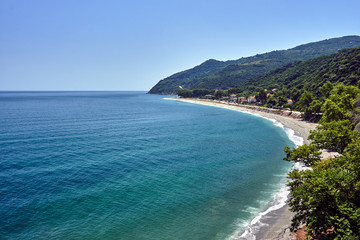 The mountainous coast of the Aegean Sea with a beach in Greece.