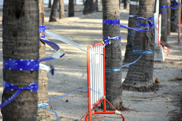 Fototapeta premium Traffic Barrier made of red iron placed on beach area for protection and ban to people use beach area. Protection to spreading from coronavirus concept.