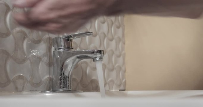 Man washing his hands in the sink