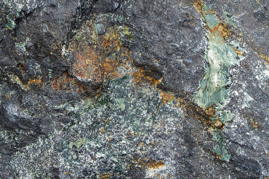 Magnetite iron ore texture close-up. Contains magnetit, pyrite, calcite, magnesioferrite, spinel, fluorite. Siberian natural resources deposit. Mineral stone surface background.