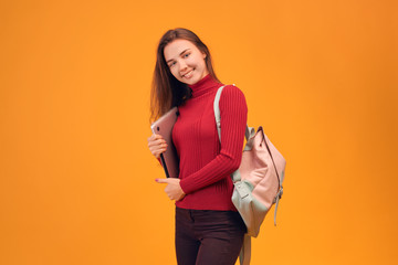 Profile of smiling girl holds laptop in hand