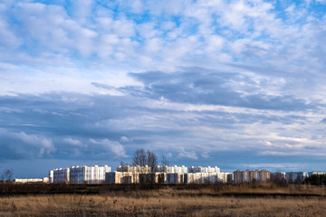 Fototapeta na wymiar High-rise buildings of the Sukhovka microdistrict in the city of Ivanovo in the rays of the setting sun.