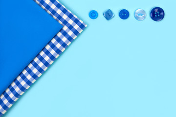Fototapeta premium Blue and white napkins on a blue background. Multi-colored linen napkins for a restaurant. Layout for design.
