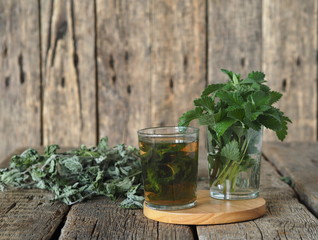 Drug plants.Herbal tea with dried Melissa or mint on a natural wooden table.