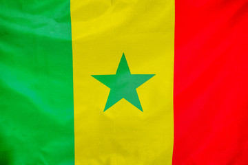 Fabric texture flag of Senegal. Flag of Senegal waving in the wind. Senegal flag is depicted on a sports cloth fabric with many folds. Sport team banner.