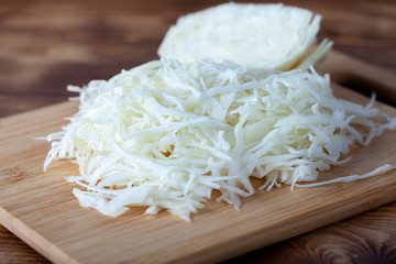 Sliced cabbage on a wooden cutting board