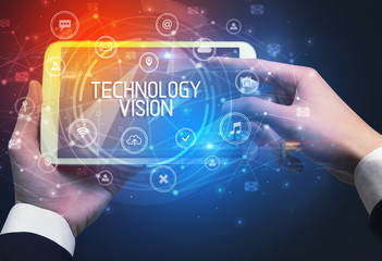 Close-up of a tablet with TECHNOLOGY VISION inscription, innovative technology concept