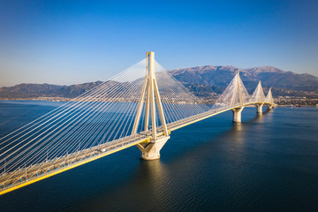 Aerial drone photo of world famous cable suspension bridge of Rio - Antirio Harilaos Trikoupis, crossing Corinthian Gulf, mainland Greece to Peloponnese, Patras