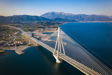 Fototapeta na wymiar Aerial drone photo of world famous cable suspension bridge of Rio - Antirio Harilaos Trikoupis, crossing Corinthian Gulf, mainland Greece to Peloponnese, Patras with city view