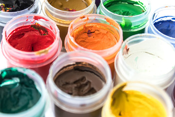 Jars with multi-colored gouache. Set for drawing, creativity and hobbies.