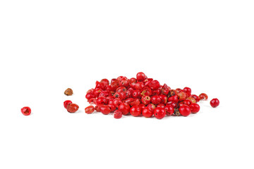 Pink peppers grains on the white background.