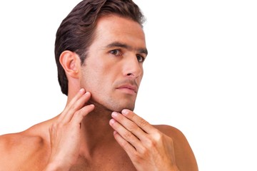 Obraz premium Cutout of attractive man checking his face in the mirror