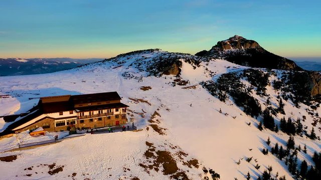 Dochia chalet and Toaca peak at sunrise in Ceahlău Mountains National in winter season, Aerial winter Landscape view from the drone