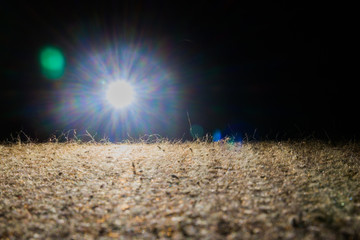 Sunrise in total darkness above a brown field. Background, space.