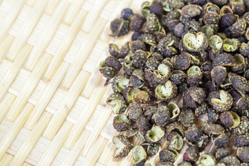 Sichuan green peppercorn close-up on bamboo basket background