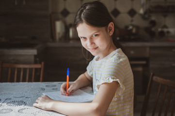 A teenager girl draws a pen in a sketchbook. Idea for quarantining a child © Kiryakova Anna
