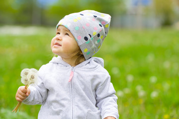 Child baby dandelion mom care summer grass green yellow background. Walks in the park holiday concept joy emotion.