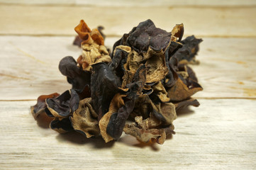 Dried Kikurage (wood ear mushroom, Jew’s ear mushroom, fungus). Wooden background.    