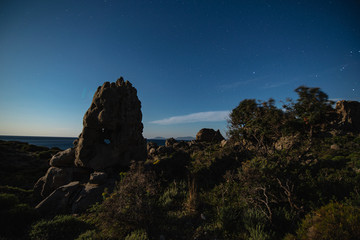 Night mountains view with star sky and full moon of the The petrified forest park in Lakonia,...