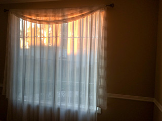 gold sunlight streams through curtains for golden design background on room wall