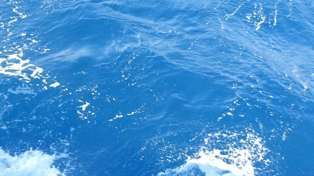 Summer Wind Raises Strong Waves in the Open Sea. They Beat Against the Deck of the Yacht and a White Foam Appears. Splatters Fly in Different Directions and then Slowly Fall onto the Water.