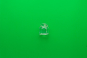Glass pot on a green background in the center
