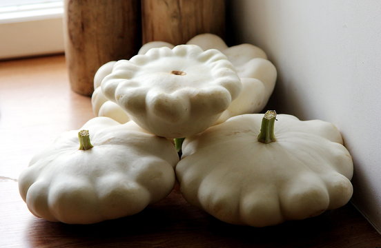 Large white organic squashes or patisons on the table