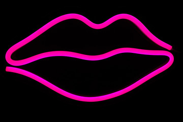 Pink lips neon sign on isolated black background. Neon concept. Modern style. Neon sign. Flat lay, copy space, top view.