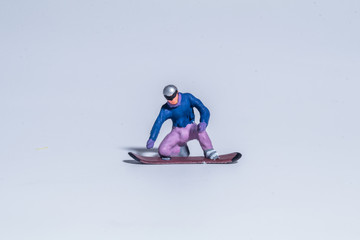Fototapeta na wymiar miniature figure concept of snowboarder