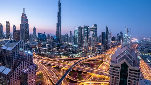 Time lapse Aerial view and top view of traffic on city streets in Dubai. Expressway with car lots. Beautiful roundabout road in the city center.